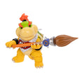 Toy figure of a yellow creature with a broom on a white background
